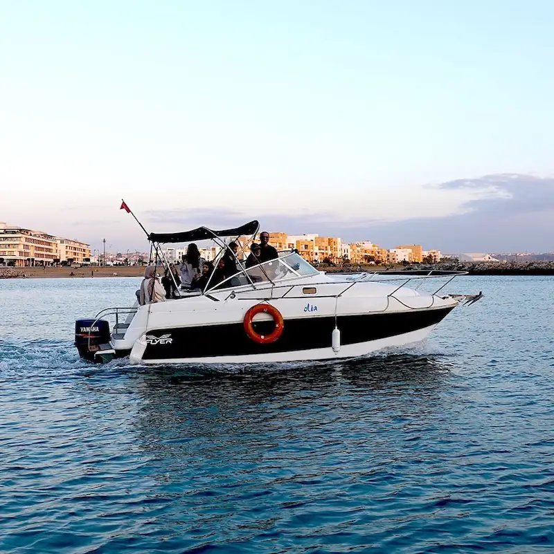 Tourists on a boat tour along the Bouregreg River in Rabat, Morocco, enjoying scenic views and historical landmarks